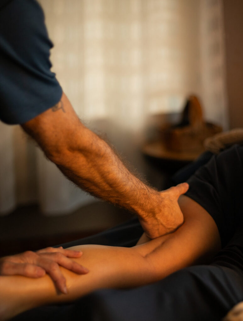 Massage Therapist Performing Deep Tissue Massage on clients lower leg